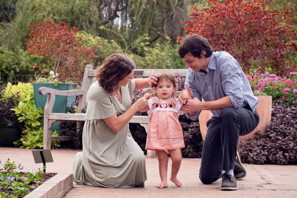 Shayanne Martin, a doctoral student at UTHealth School of Public Health in San Antonio, and her husband Jeremy share a moment with their daughter, Cora, as she was learning to walk. Courtesy photo.